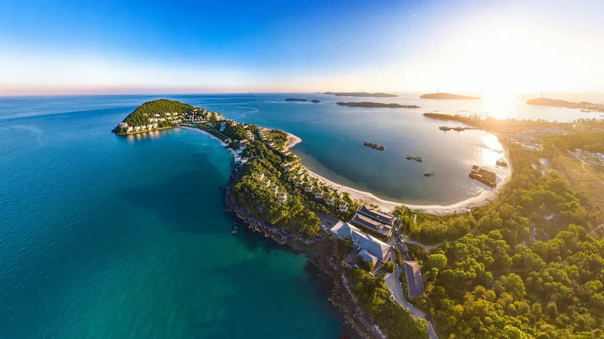 Aerial view of a luxury tropical resort on the turquoise coastline of Phu Quoc Island, Vietnam at sunset