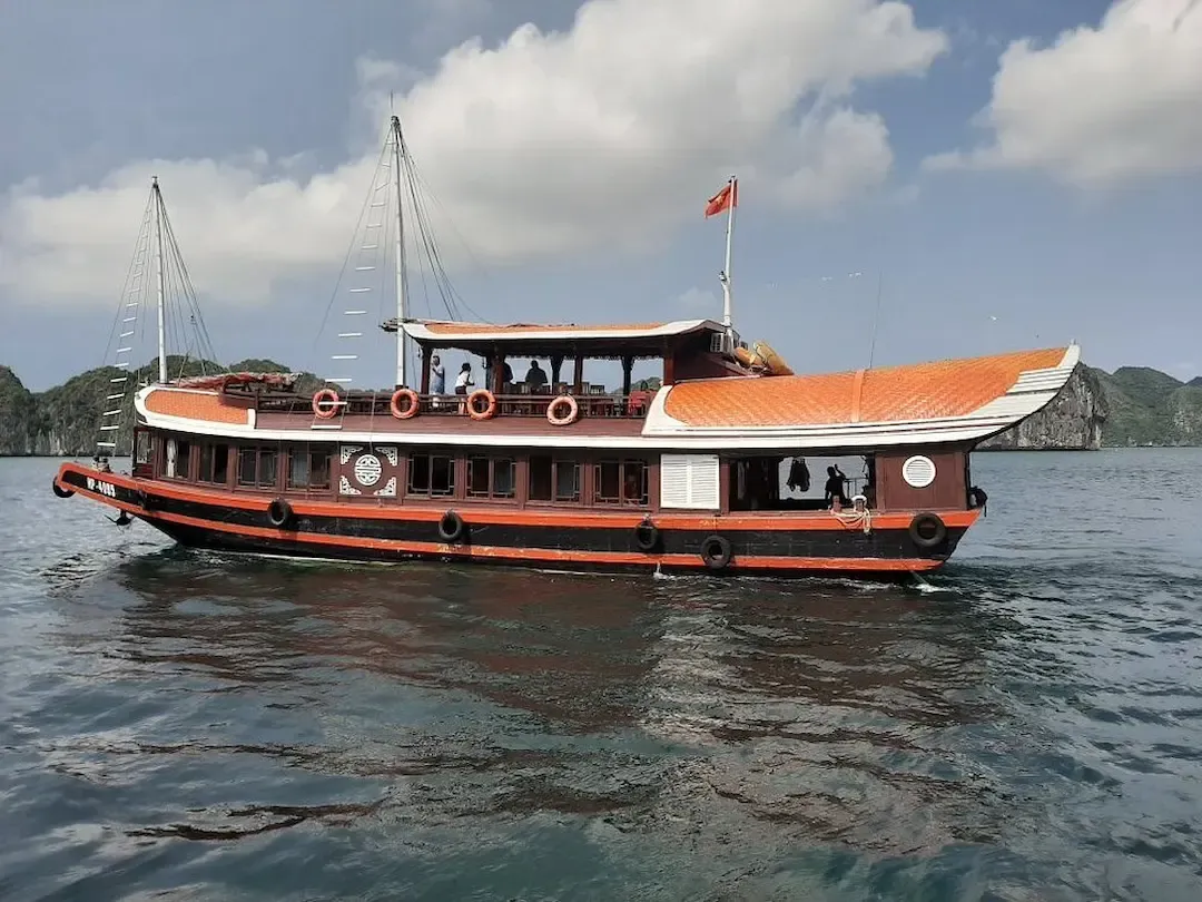 Classic Wooden Indochine Junk Cruise With Orange Roof Sailing Through Lan Ha Bay Vietnam