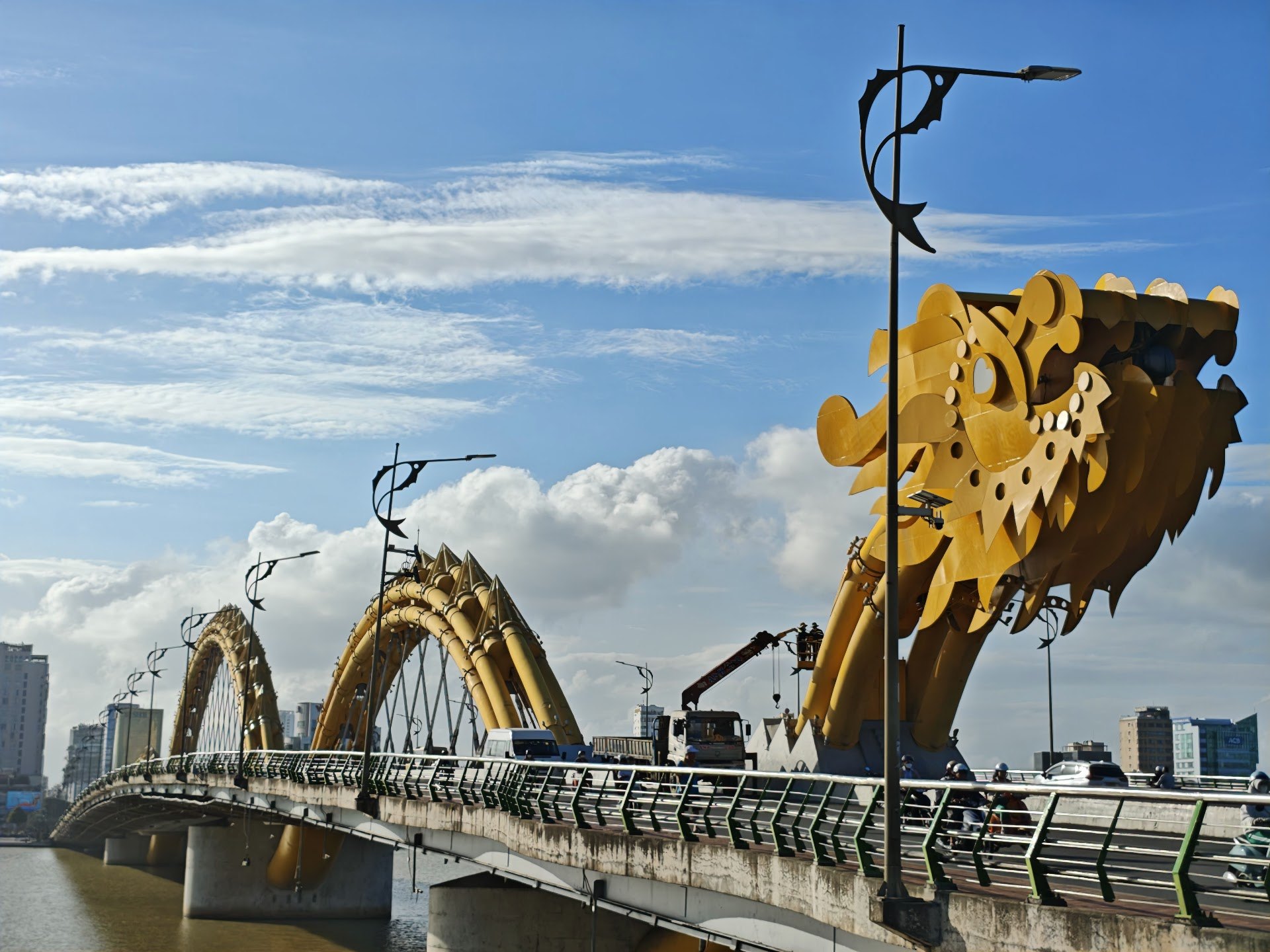Yellow dragon arches and street lamps along Dragon Bridge in Da Nang