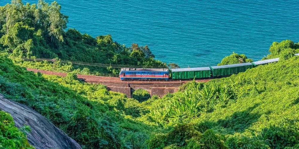 Train Traveling Through Green Mountains Near the Ocean in Vietnam