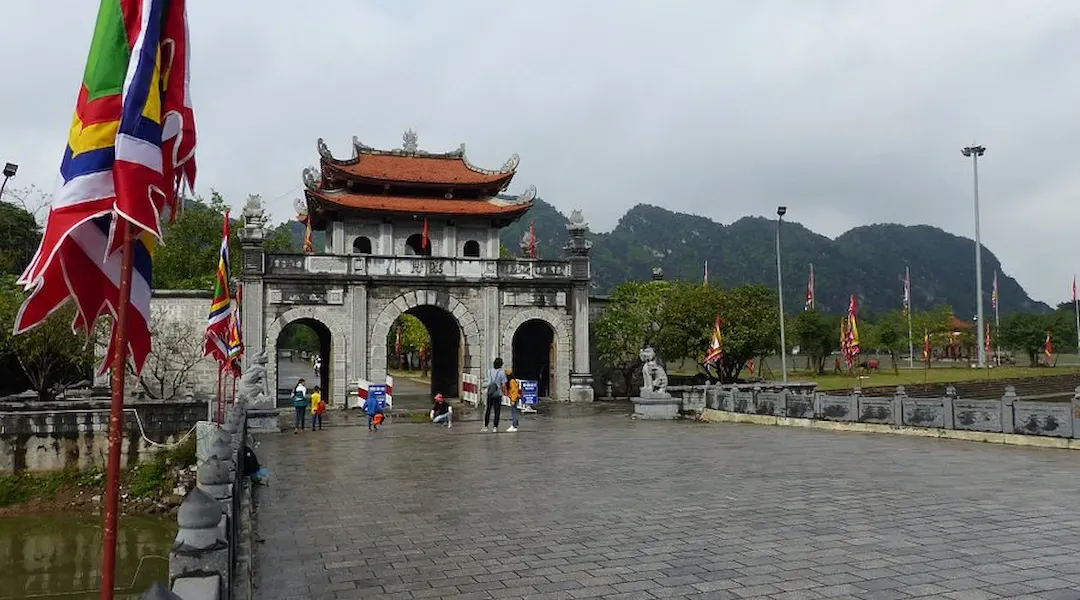 Dinh Tien Hoang King Temple Meridian Gate Entrance With Traditional Vietnamese Architecture and 1100 Year Anniversary Celebration Banner at Hoa Lu Ancient Capital Ninh Binh