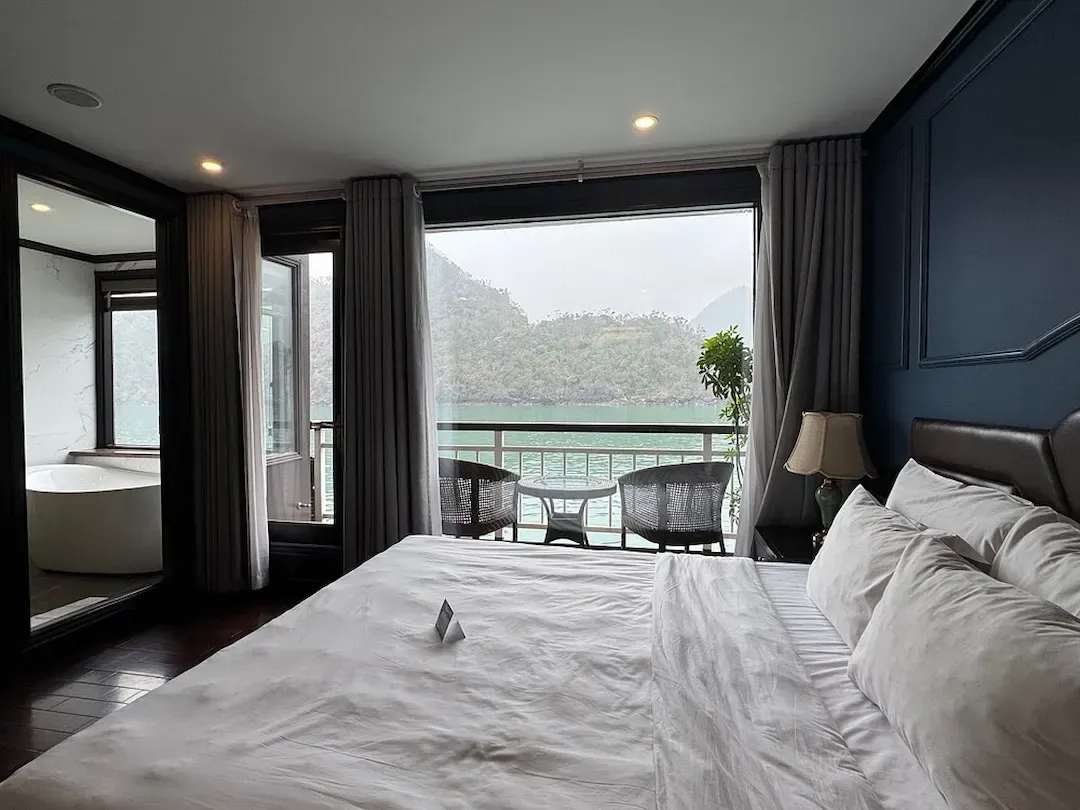Lan Ha Bay Luxury Cruise Balcony Cabin With King Bed and Floor to Ceiling Windows Over Turquoise Water