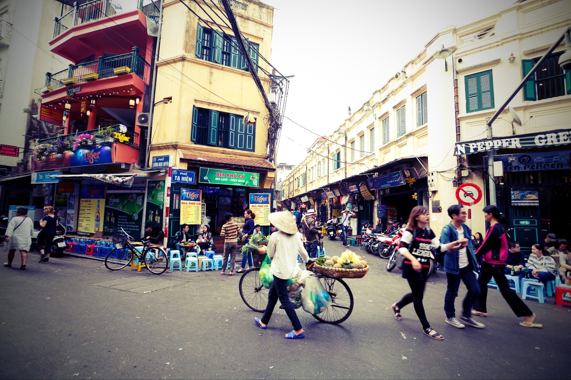 Low plastic stools and beer signs at the Ta Hien crossroads in Hanoi's Old Quarter
