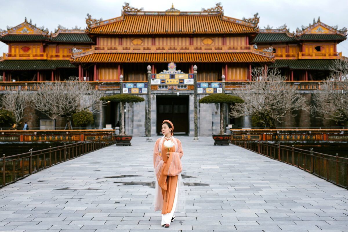 a Woman in Traditional Dress Walking Toward the Imperial City in Hue, Vietnam