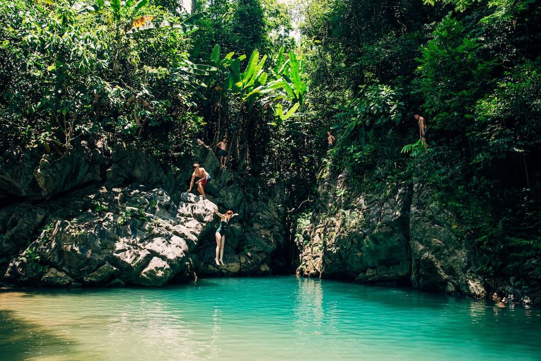 Travelers Cliff Jumping on the Elephant Cave Tour