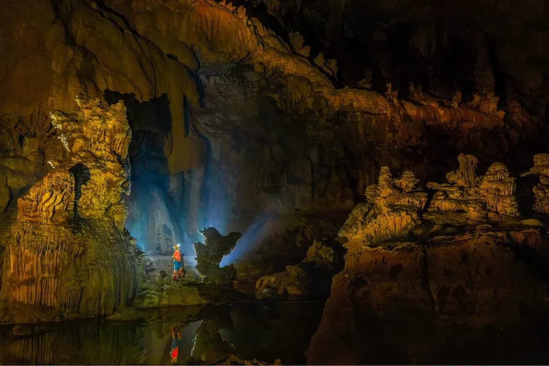 Tiger Cave interior with dramatic stalactites during Kong Collapse multi-day expedition at Phong Nha Vietnam