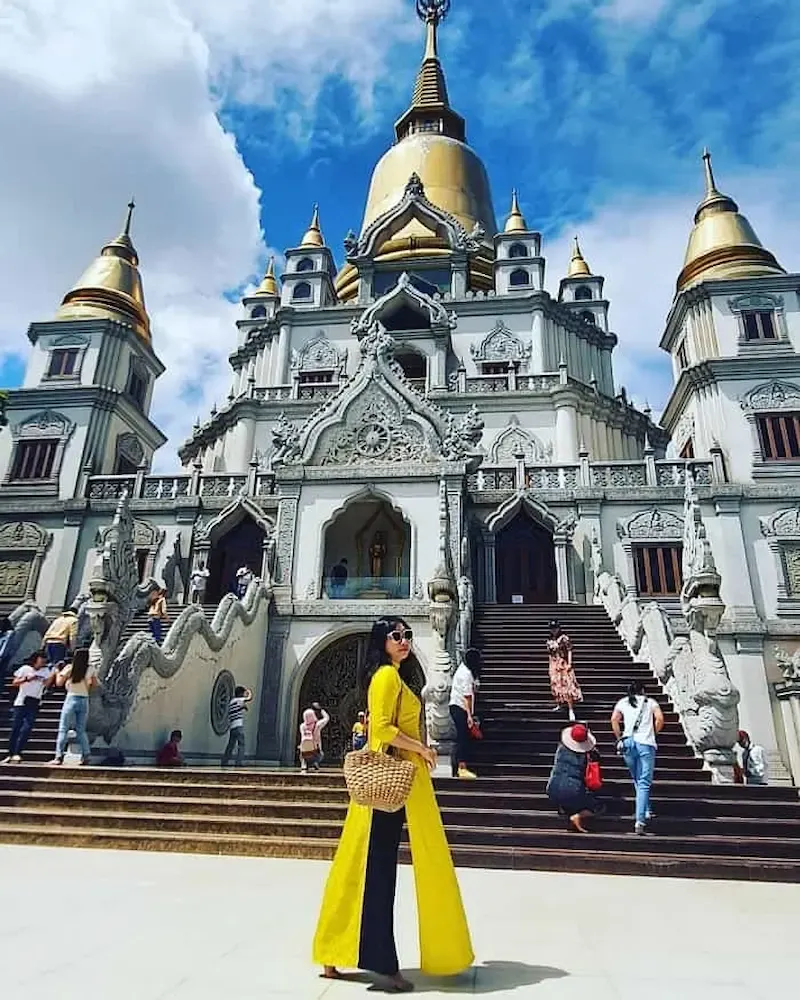 a Woman Posing in Front of Beautiful Buu Long Pagoda