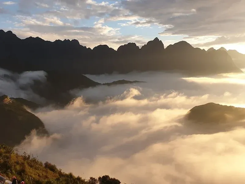 Golden Sunrise Over a Sea of Clouds With Jagged Mountain Silhouettes Near Rong May Glass Bridge, Sapa