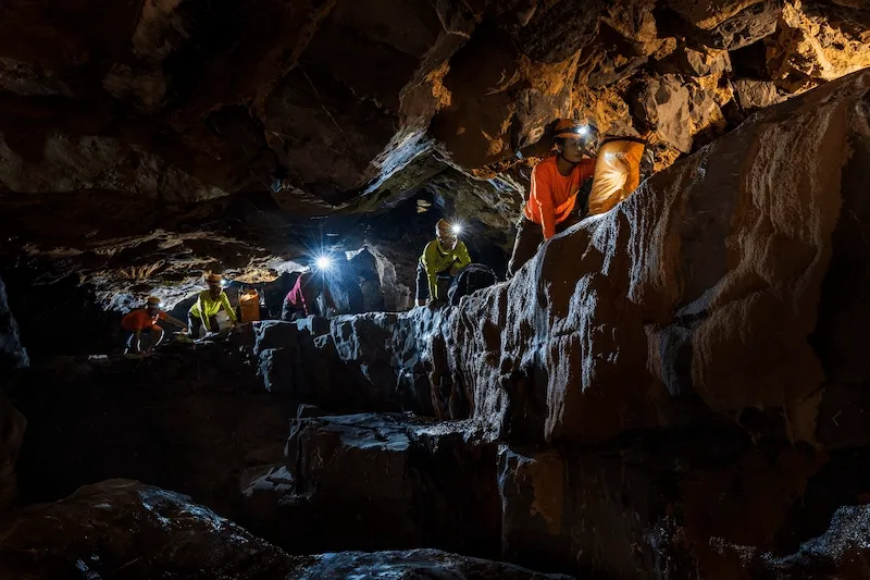 Group crossing a chamber inside the Tiger Cave system