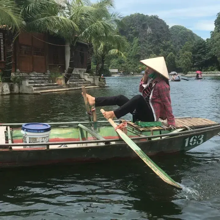Foot Rowing by a Boat Vendor in Tam Coc