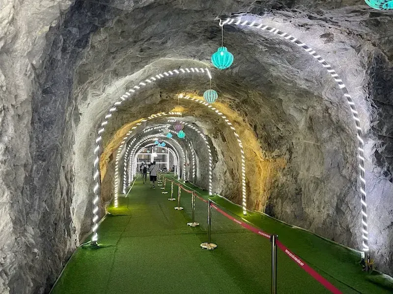 Illuminated Rock Tunnel Walkway Leading to the Sapa Glass Bridge Attraction