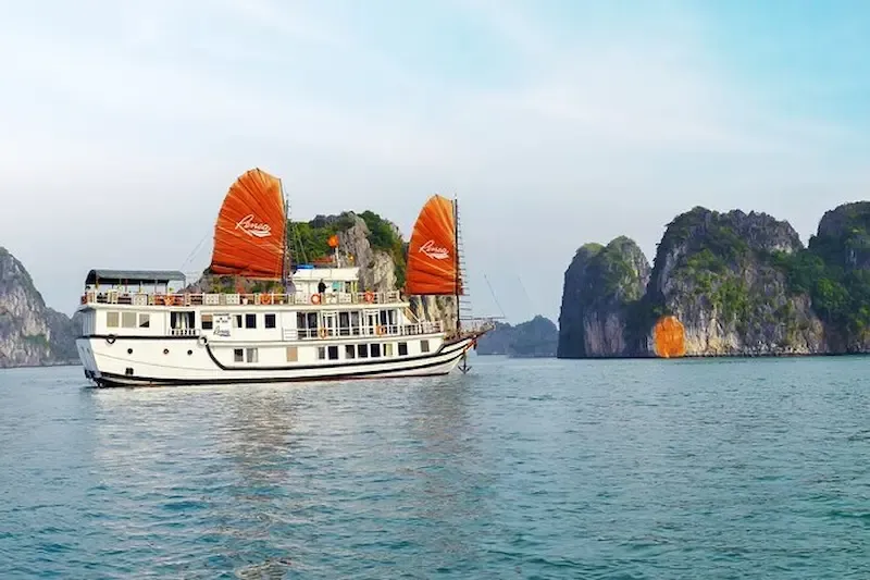 Aerial View of Luxury Cruise Ship Anchored in Pristine Turquoise Waters of Bai Tu Long Bay Surrounded by Limestone Island Formations   2 Night Cruise Destination