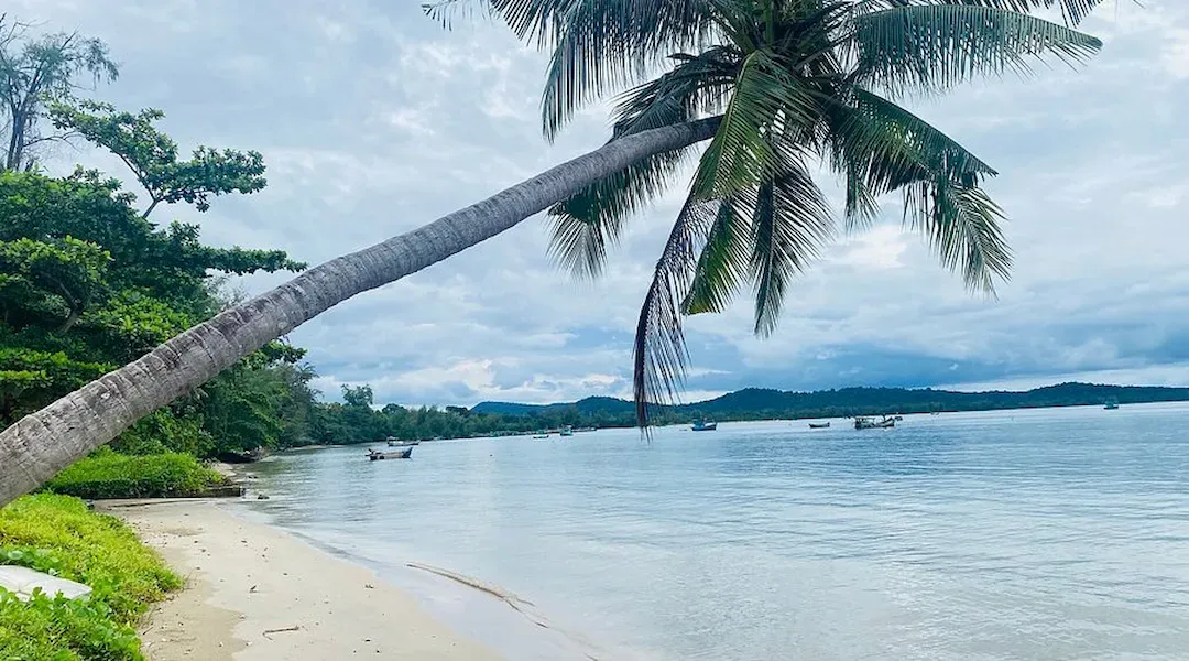 Vung Bau Half Moon Beach Phu Quoc with crescent shaped cove, turquoise waters, palm trees and rocky headlands