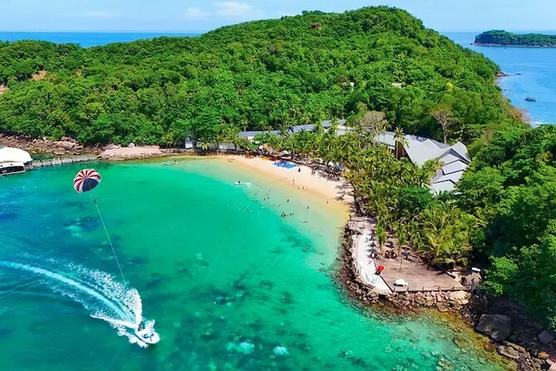 Parasailing Over Turquoise Waters Near a Tropical Beach Cove in Phu Quoc Island