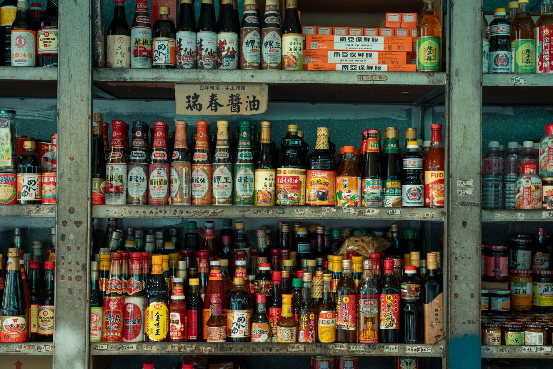 Bottles of fish sauce and shrimp paste on a shelf in a Vietnamese kitchen