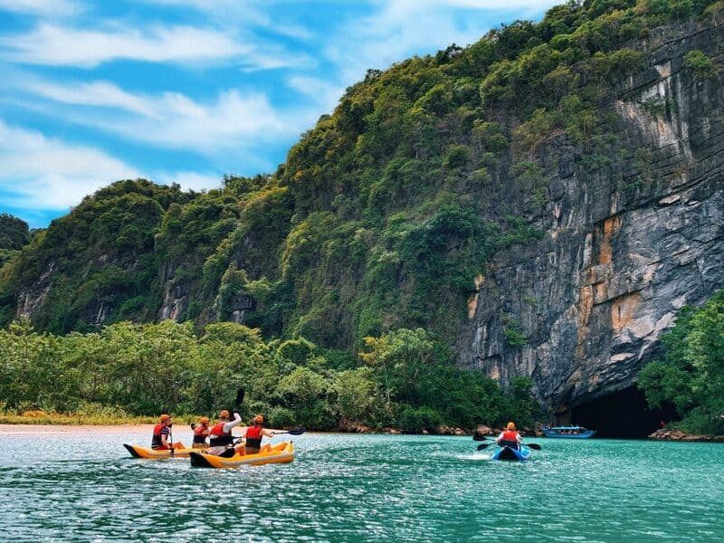 2. Tourists Kayaking Toward a Cave in Phong Nha