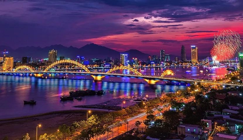 Nighttime View of Da Nang City With the Illuminated Dragon Bridge and Fireworks in the Sky