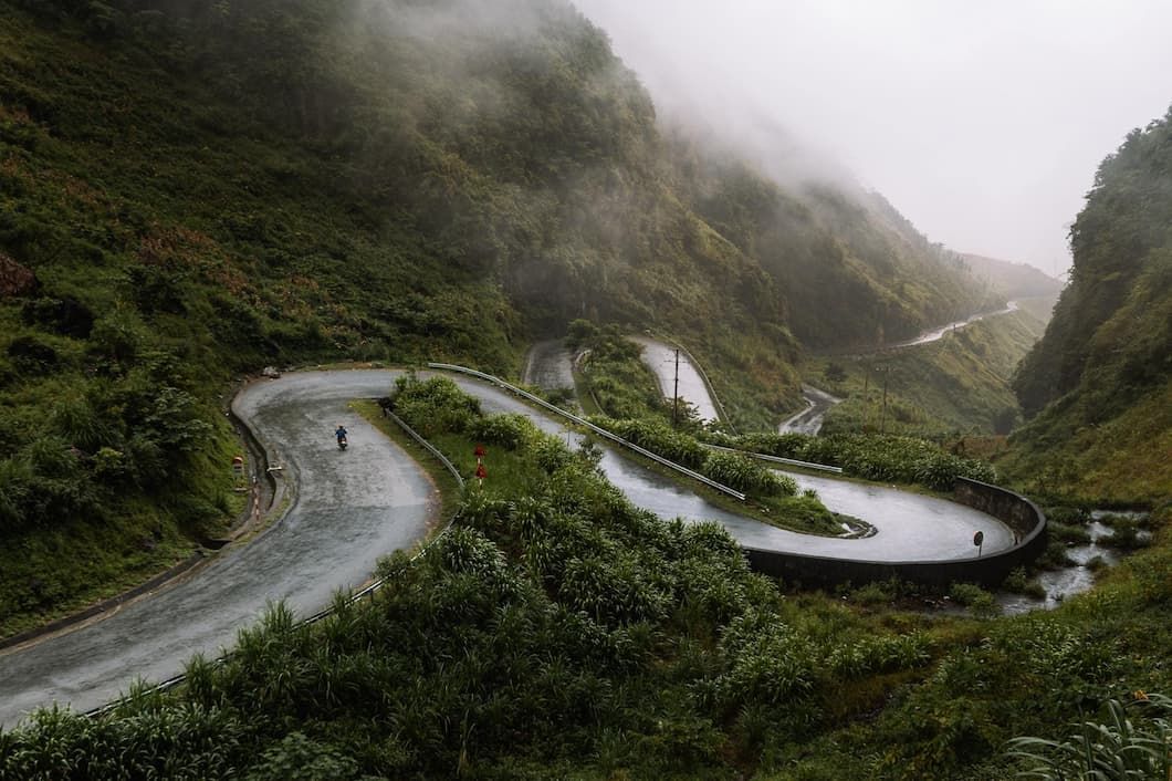 a Winding Road Through a Misty, Mountainous Landscape With Lush Greenery in Vietnam