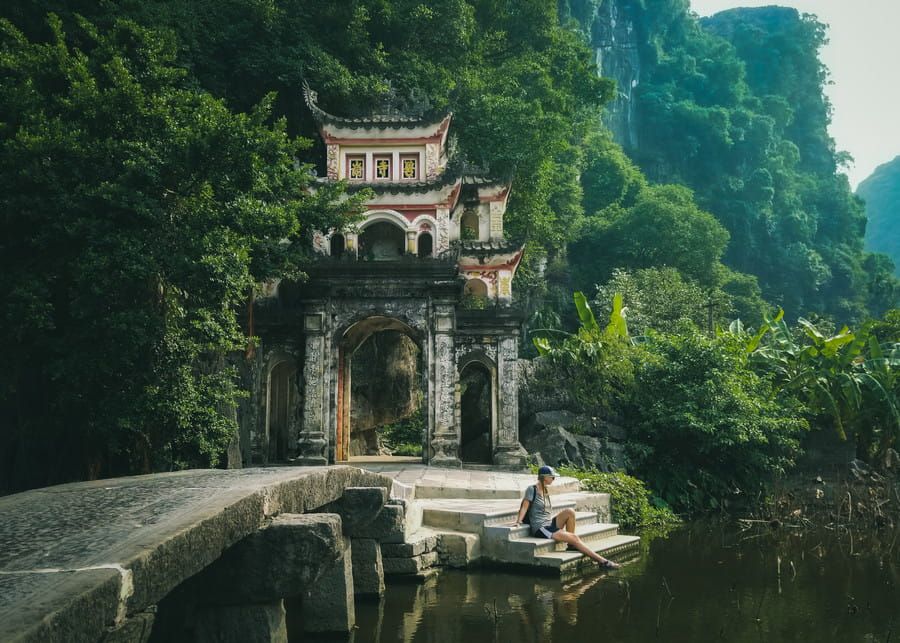 Scenic View of the Ancient Bich Dong Pagoda Nestled in Lush Greenery.