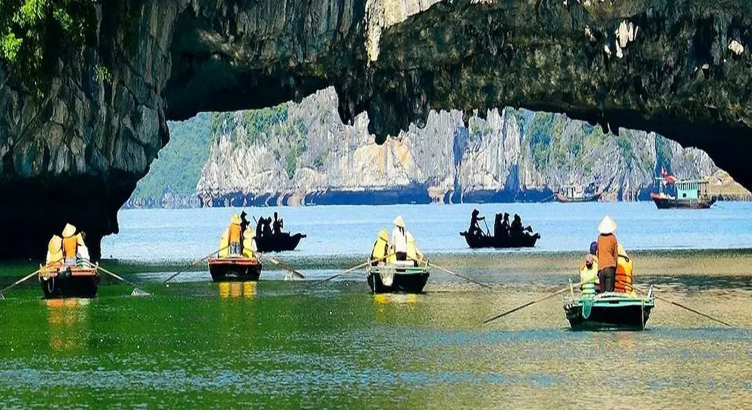Multiple Colorful Traditional Boats in Bai Tu Long Bay Fishing Village With Limestone Cliff Backdrop   Moderate Tourism, Authentic Experience, Not Overcrowded