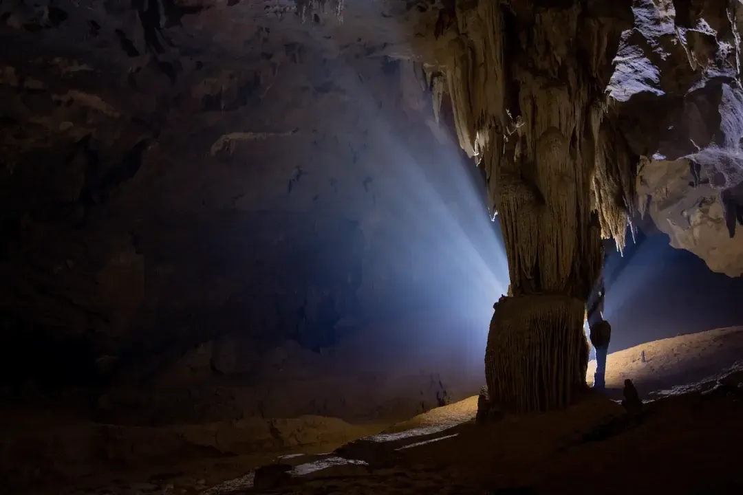 Professional backlit photography of a massive cave pillar in Nuoc Nut Cave, Phong Nha.