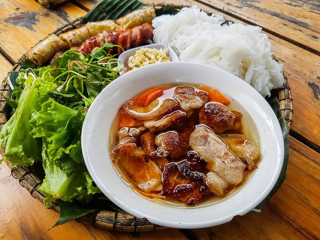 Traditional Phong Nha Dish With Grilled Pork and Fresh Greens