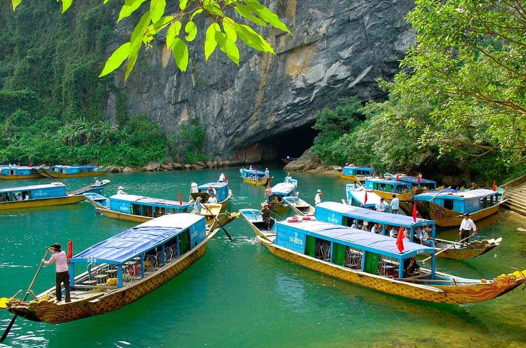 2. Traditional Wooden Boats Gathered at the Entrance of Phong Nha Cave, Ready for a River Tour.
