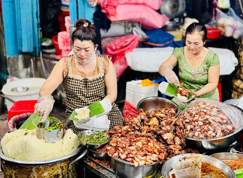 Women Cooking Street Food at the Ba Chieu Market in Ho Chi Minh