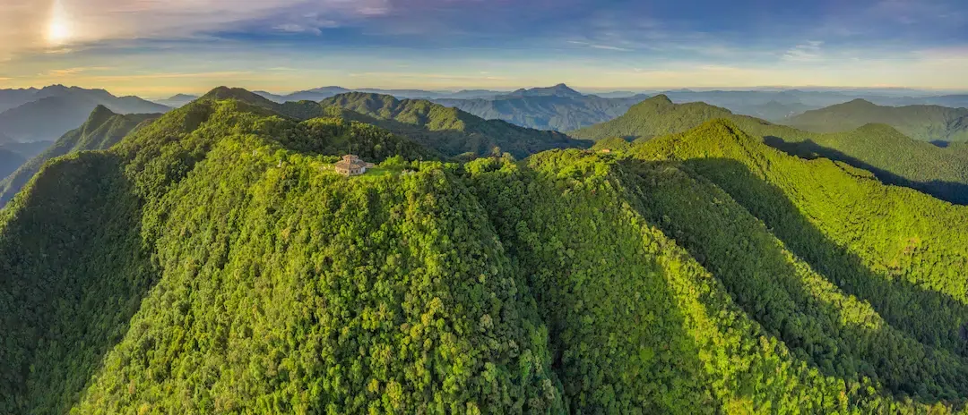 Aerial view of the Hai Vong Dai observation building on a lush green mountain peak in Bach Ma National Park near Hue